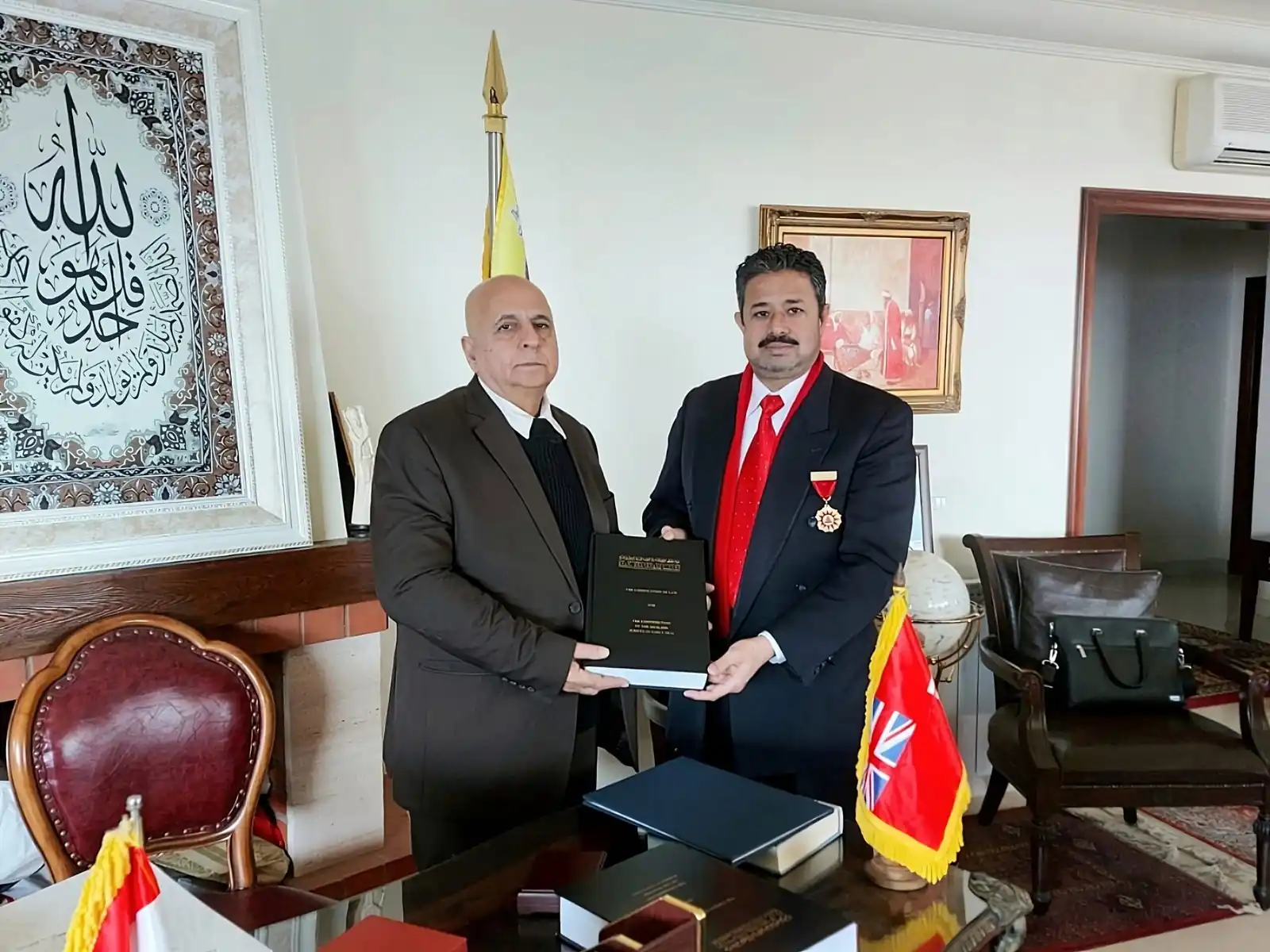 A bound thesis being presented in an office