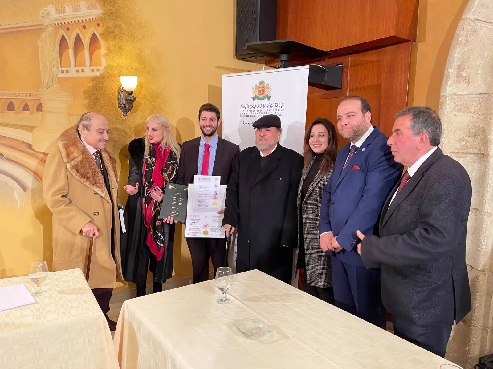 A graduate and guests with a newly awarded certificate